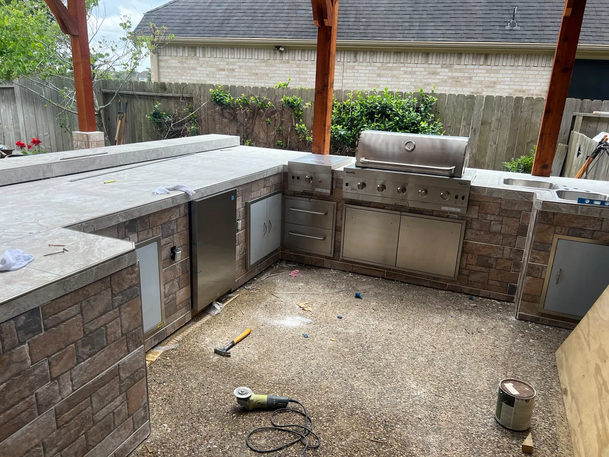 Stone outdoor kitchen with a built-in grill under construction